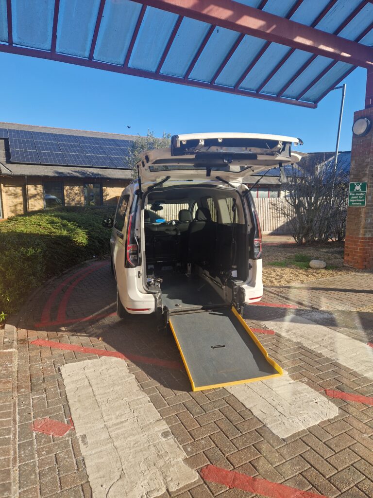Wheelchair accessible taxi with rear ramp for large and electric vehicles